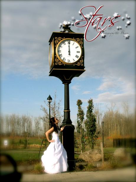 So much fun A young women in a wedding dress looking up at a clock tower 